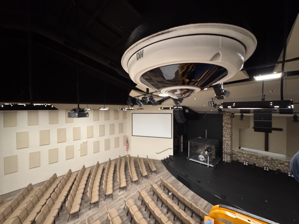 A video surveillance dome camera installed above the sanctuary seating.
