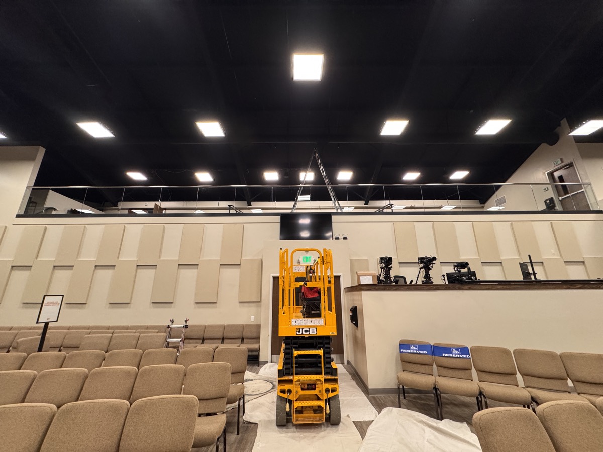 A lift positioned in the sanctuary aisle during the technology installation.
